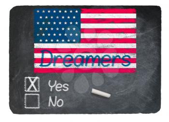 Dreamers Yes Vote message written in chalk on a chalky natural slate blackboard for current debate over Dreamers