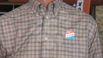 I Voted Today sticker on the shirt of a casually dressed senior caucasian man for midterm elections in the USA