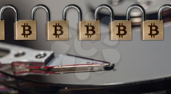 Chained set of locks linked into a chain to ilustrate the concept of Blockchain and Bitcoin on top of computer hard drive