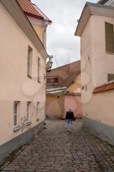 TALLINN, ESTONIA - SEPTEMBER 14: Solitary tourist in Toompea above the old town on September 14, 2017 in Tallinn, Estonia. It became a city in 1248.