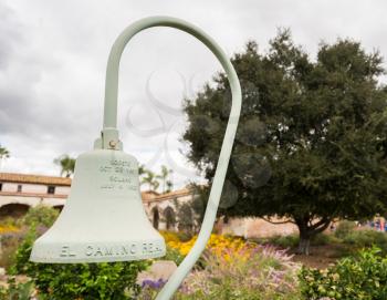 El Camino Real cast iron bell in garden of the Mission at San Juan Capistrano, California