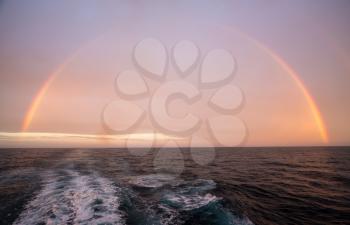 Full circle of rainbow over Atlantic ocean from cruise ship