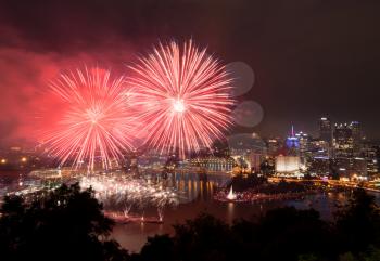PITTSBURGH, PA - JULY 4, 2018: Fireworks from the river in front of downtown Pittsburgh on Independence Day.