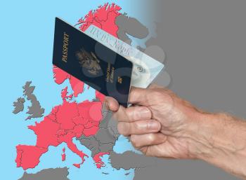 Senior man holding US passport on map of Schengen Zone of European Union in preparation for ETIAS visa