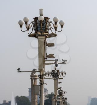 Detail of light posts and security cameras in Tiananmen Square in Beijing