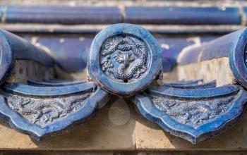 Ornate pottery tiles and carvings on roof of Temple of Heaven in Beijing, China