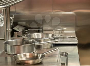 Food being cooked in commercial stainless steel kitchen in restaurant