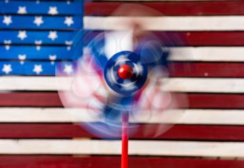 Independence day concept with pin wheel or whirligig in front of a USA Flag