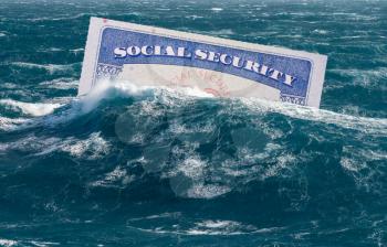 Social Security card sinking underwater in stormy seas as concept for issues around funding of USA pensions to seniors