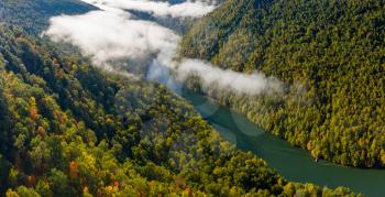 Aerial drone image of the Cheat River flowing through narrow wooded gorge in the autumn towards Cheat Lake near Morgantown, WV