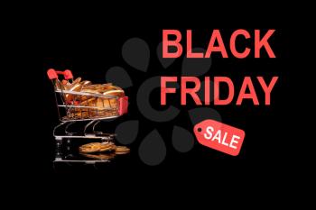 Mockup or background advert for Black Friday with shopping cart filled with gold coins to illustrate savings to be found in the sales