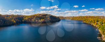 Aerial drone panorama of the autumn fall colors surrounding Cheat Lake over the interstate I68 bridge near Morgantown, West Virginia