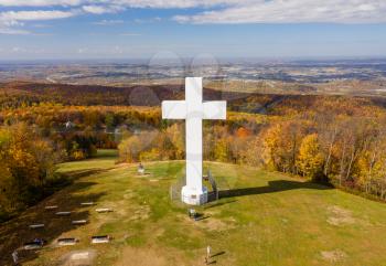Aerial drone view of the metal structure of the Great Cross of Christ on Dunbar's Knob in Jumonville, PA