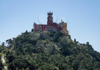 Pena Palace monument on the hilltop seen from the Castle of the Moors near Sintra in Portugal