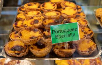 Display of Portuguese custard tarts or Pasteis de Nata in a bakery in Porto, Portugal