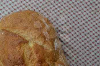 Bread. A loaf of bread. Freshly baked bread. Food. Kitchen. Tablecloth. Delicious. Close-up. Horizontal photo