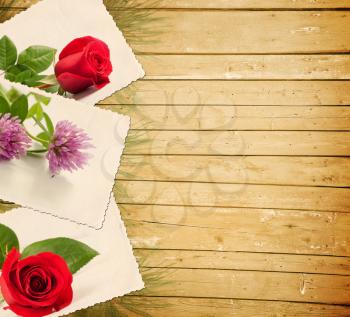 Old photo with flowers on a wooden background