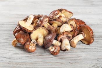 Edible wild mushrooms on a wooden background
