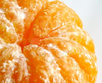 Peeled tangerine or mandarin fruit close up