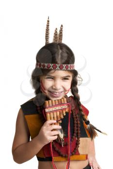 Little Girl dressed as an Indian plays Pan's flute and laughs