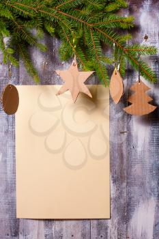 Christmas decoration of fir branches and toys on gray door