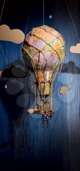 Strange steampunk balloon which flies between clouds and aims for the stars