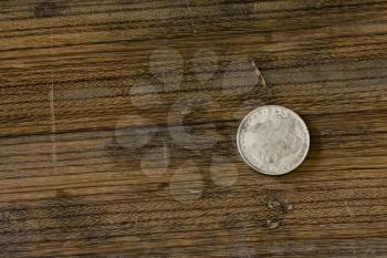 vintage American silver dollar lying on an oak board