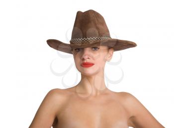 portrait of a young slender girl with bare shoulders looking thoughtfully at a cowboy hat on her head