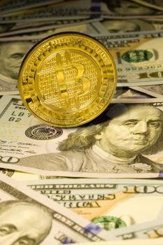 Internet currency Coin Bitcoin on the background of lying one hundred dollar bills