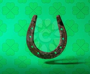 old classic horseshoe symbol of good luck on top of a bright green background with clover leaves