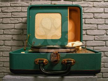 old green electric gramophone with music record