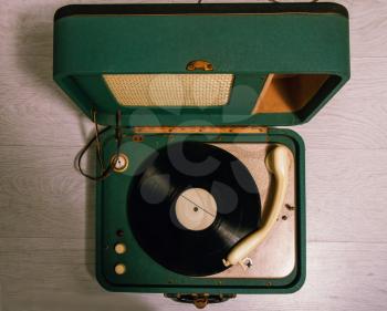 old green electric gramophone with music record top view