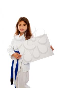 karate girl with a blue belt and a white kimono is holding a blank sheet of paper with a place for text
