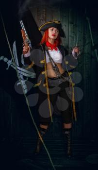 Young Attractive Armed Girl Pirate Captain Shoots Pistol Jolly Roger Flag Background