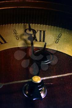 old analog clock close-up of the hands of which show at twelve o'clock