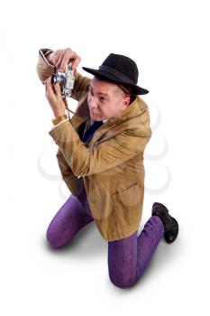 adult news photographer in a costume of the last century fashion and a wide-brimmed hat with an old camera