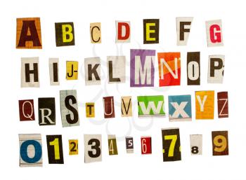 latin alphabet and numbers for anonymous letters in order to remain unidentified cut out by scissors from different newspapers isolated on white background