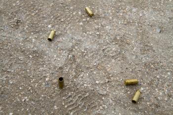 several pistol shells scattered after firing on the ground