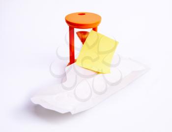 White feminine sanitary pad with empty yellow paper for text and an hourglass measuring time to start or end