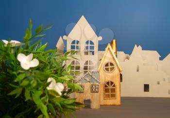 A street of cardboard and wood cut houses imitating a small cute European city on a dark blue background