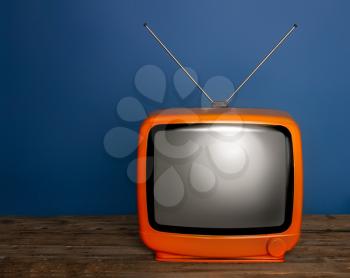 old bright vintage tv with blank screen and antenna on dark background