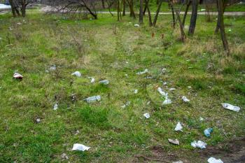 Nikolaev, Ukraine - 06 april 2021: Garbage in the park. Garbage, empty wrappers, packaging left by people after relaxing in the park in nature