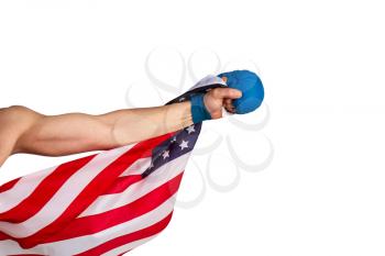 A strong male hand in a karate and martial arts glove wrapped in the Stars and Stripes USA flag strikes forward