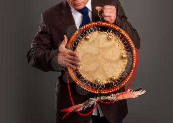 The man plays the tambourine. According to legends, every system administrator, when something breaks down in the server room, must perform a magic ritual using a shaman tambourine.