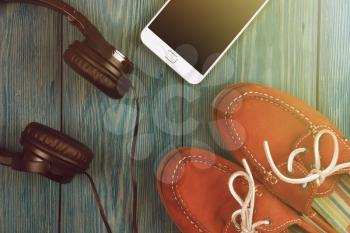 Music online concept - phablet and headphones on the wooden desk
