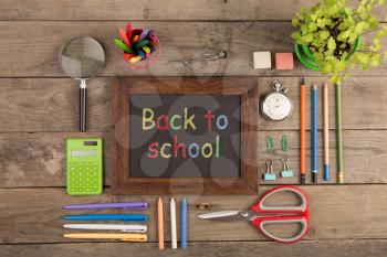 Back to school concept - school supplies on the wooden desk