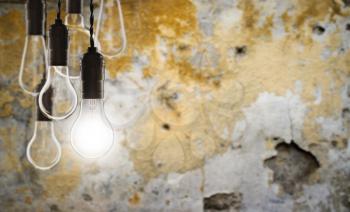 Idea and leadership concept - Vintage bulbs on the grunge background