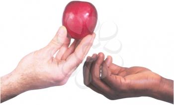 Royalty Free Photo of an Apple Being Passed From One Hand to Another