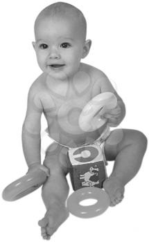 Royalty Free Black and White Photo of an Infant Child Sitting, Playing with Toys 