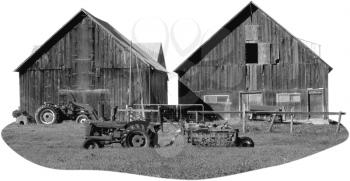 Royalty Free Black and White Photo of Two barns and Tractors